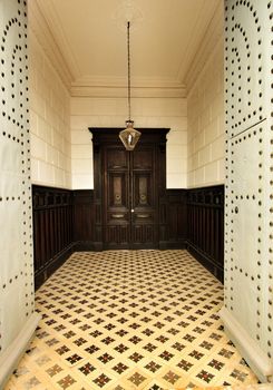 Entrance of majestic modernist style house in Alicante. Beautiful door with forged metal details and typical tiled floor