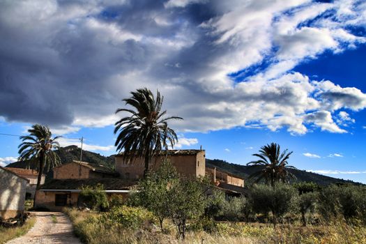 Beautiful country house in Hondon de las nieves, Alicante province, Spain, under cloudy sky and surrounded by vegetation