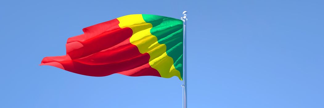 3D rendering of the national flag of Congo waving in the wind against a blue sky