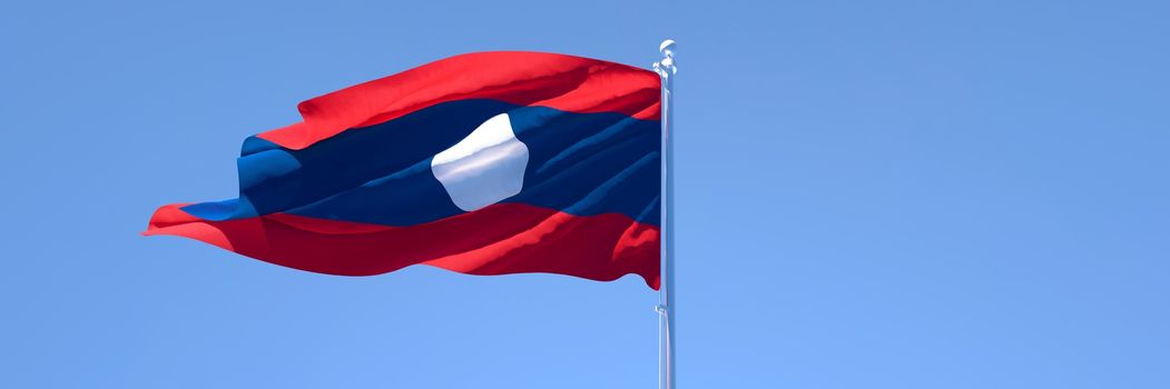 3D rendering of the national flag of Laos waving in the wind against a blue sky