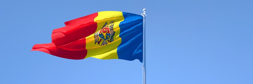 3D rendering of the national flag of Moldavia waving in the wind against a blue sky