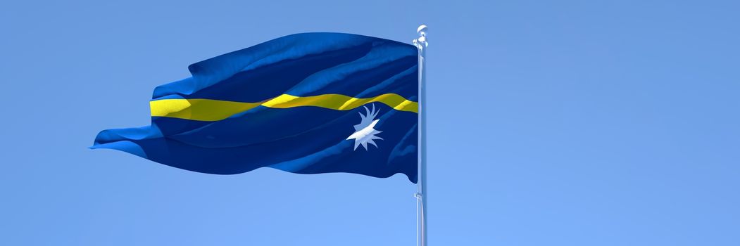 3D rendering of the national flag of Nauru waving in the wind against a blue sky