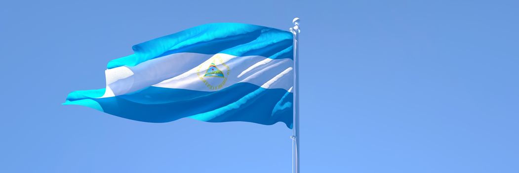 3D rendering of the national flag of Nicaragua waving in the wind against a blue sky