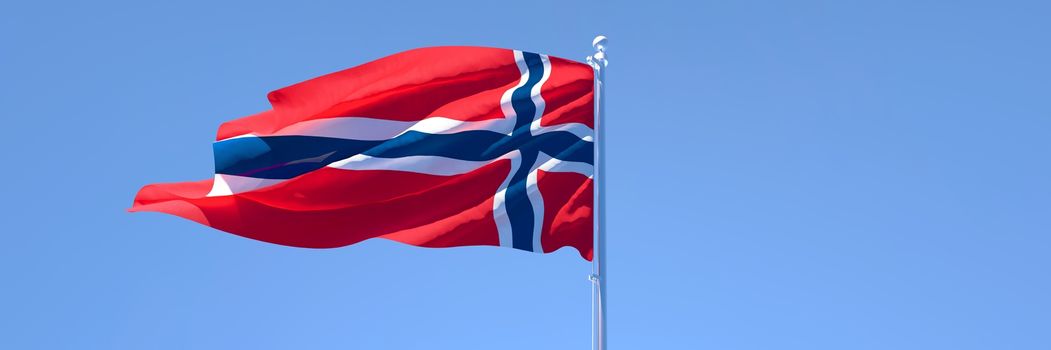 3D rendering of the national flag of Norway waving in the wind against a blue sky