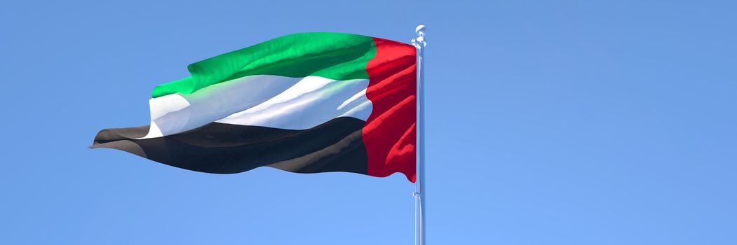 3D rendering of the national flag of UAE waving in the wind against a blue sky