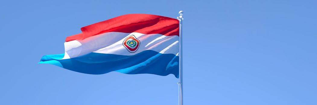 3D rendering of the national flag of Paraguay waving in the wind against a blue sky