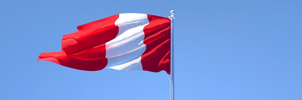 3D rendering of the national flag of Peru waving in the wind against a blue sky