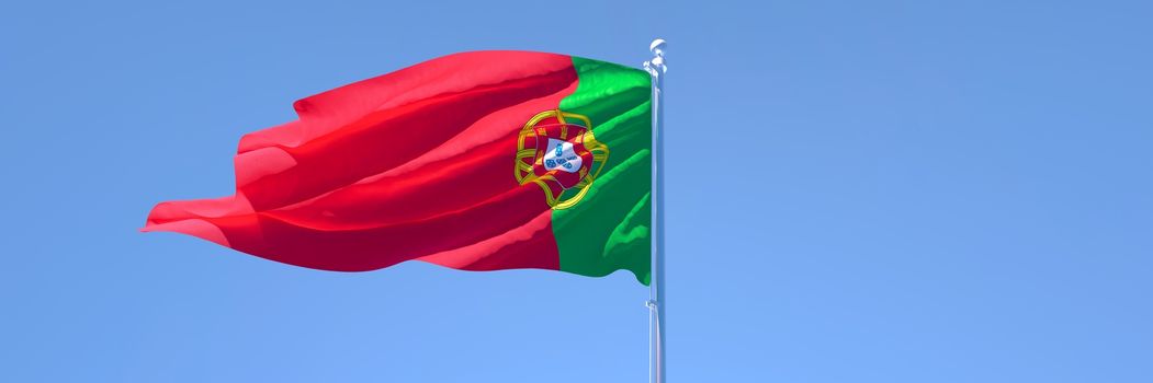 3D rendering of the national flag of Portugal waving in the wind against a blue sky