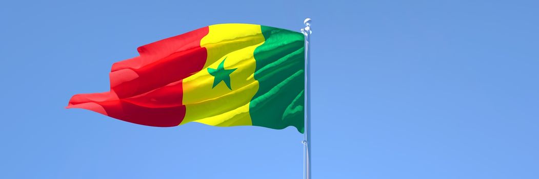 3D rendering of the national flag of Senegal waving in the wind against a blue sky