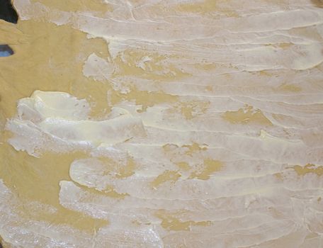 Rolled out and spread with butter and butter for baking