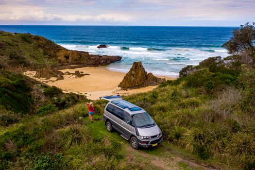 Freedom female on road trip vacation holiday by ocean on coast of Australia