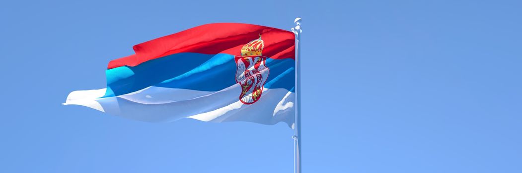 3D rendering of the national flag of Serbia waving in the wind against a blue sky