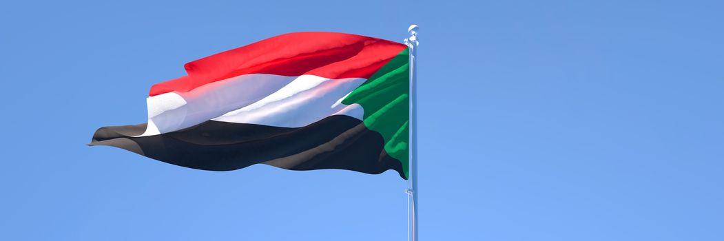 3D rendering of the national flag of Sudan waving in the wind against a blue sky