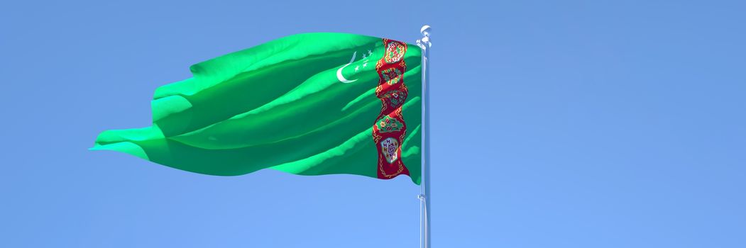 3D rendering of the national flag of Turkmenistan waving in the wind against a blue sky