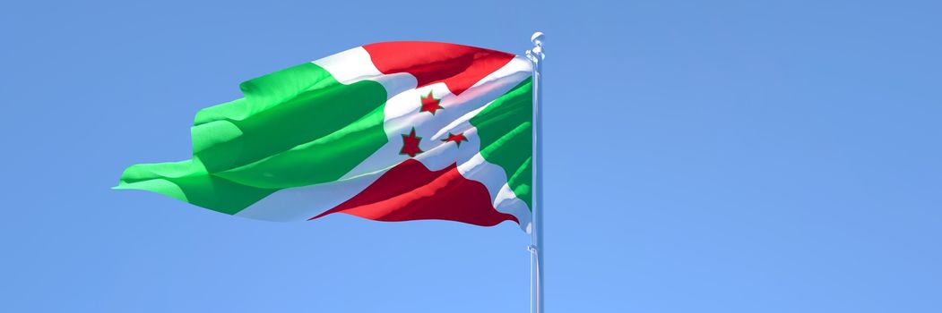 3D rendering of the national flag of Burundi waving in the wind against a blue sky