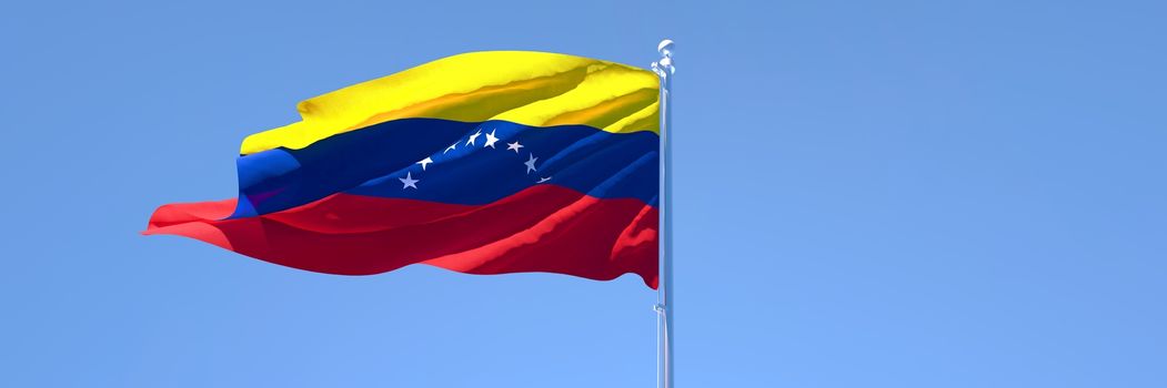 3D rendering of the national flag of Venezuela waving in the wind against a blue sky