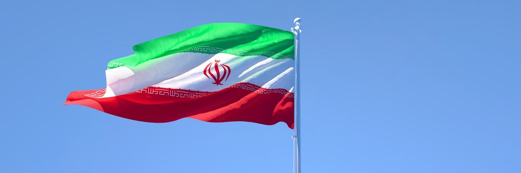 3D rendering of the national flag of Iran waving in the wind against a blue sky