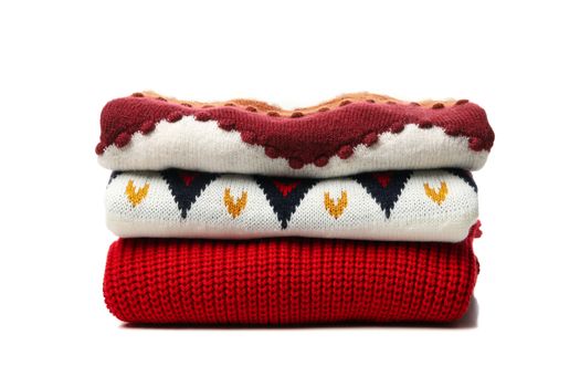 Pile of sweaters isolated on white background