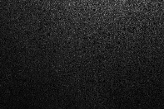 Dark full frame background of hammered powder paint coating on flat sheet steel surface. Also known as hammertone effect.