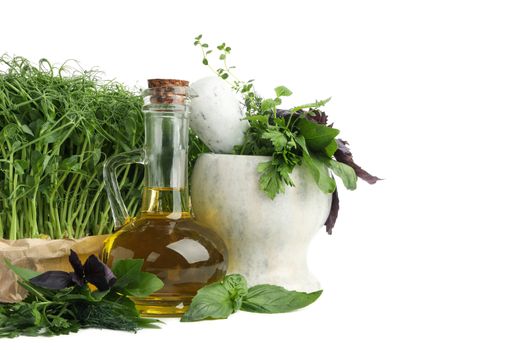 Different herbs, oil and marble mortar isolated on white background