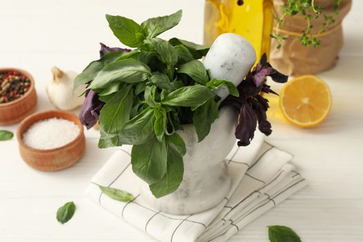 Different herbs, oil and spices on white wooden table