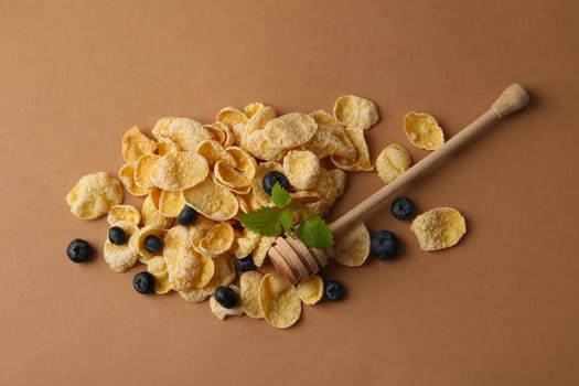 Muesli, blueberry, dipper and mint on brown background