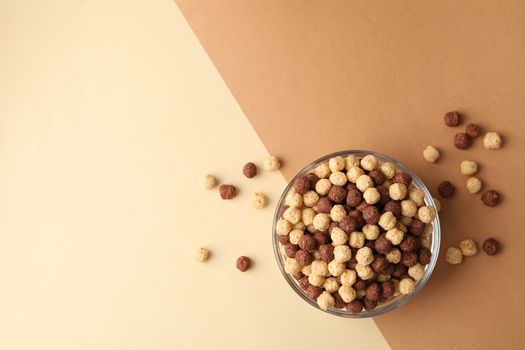 Bowl with corn balls on two tone background