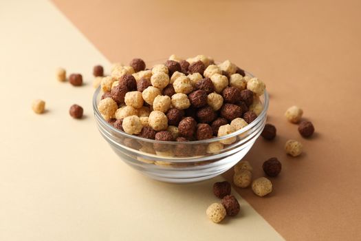 Bowl with corn balls on two tone background