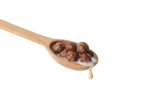 Spoon with corn balls and milk isolated on white background