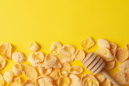 Tasty muesli and dipper on yellow background