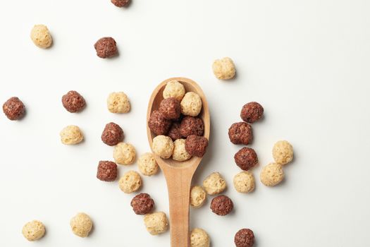 Spoon with corn balls on white background