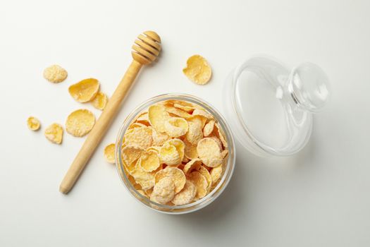 Dipper and jar of muesli on white background