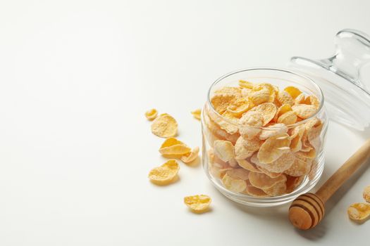 Dipper and jar of muesli on white background