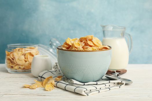 Concept of breakfast with muesli and milk on white wooden table