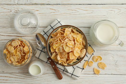 Concept of breakfast with muesli and milk on white wooden table