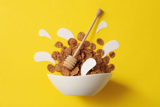 Bowl with muesli and dipper on yellow background