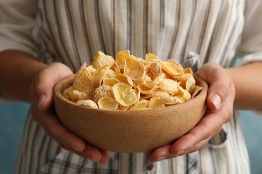 Woman hold bowl of muesli, close up