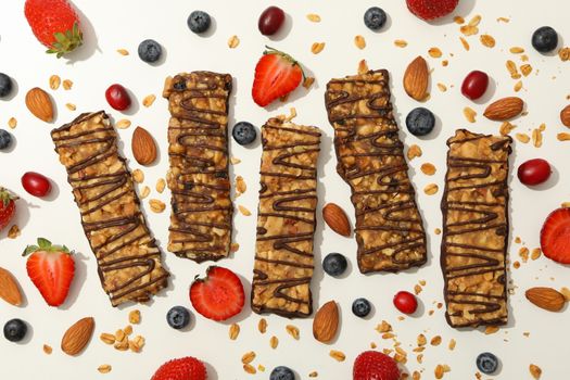 Tasty granola bars on white background, top view