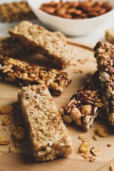 Tray with granola bars and bowl with almond, close up