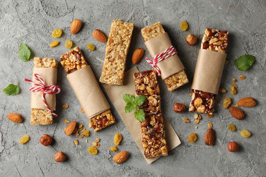 Tasty granola bars on gray background, top view