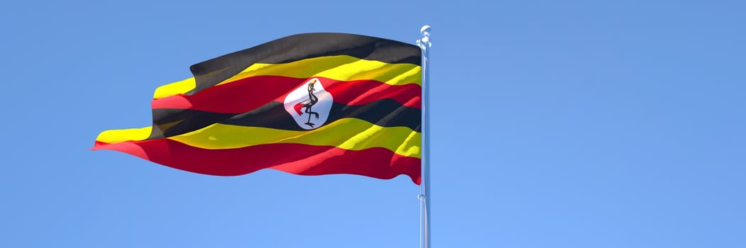 3D rendering of the national flag of Uganda waving in the wind against a blue sky