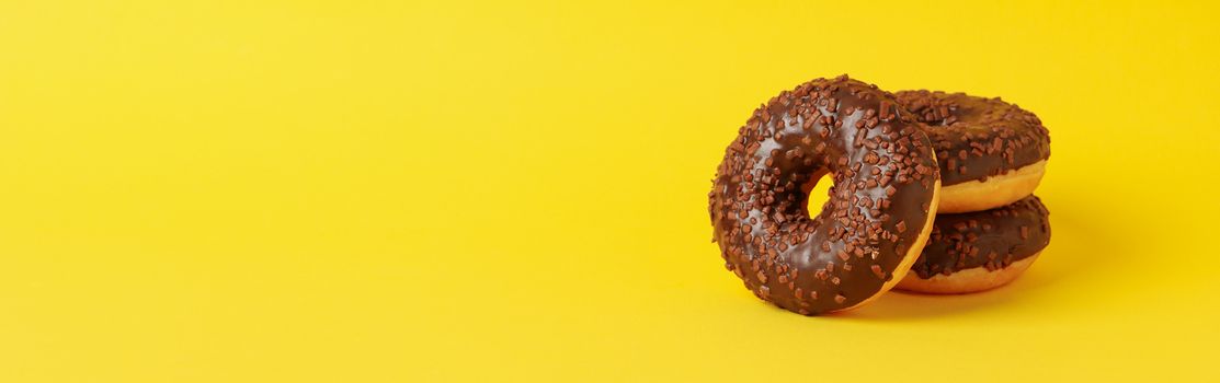 Tasty donuts on yellow background, space for text