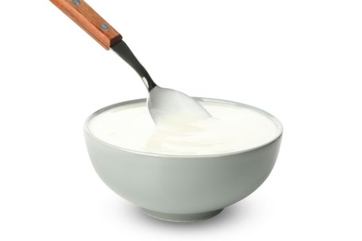 Bowl of sour cream yogurt and spoon isolated on white background