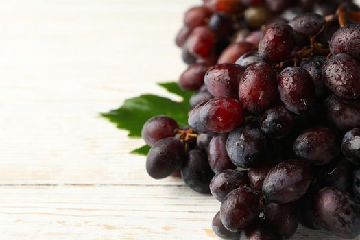 Fresh ripe grape on white wooden background