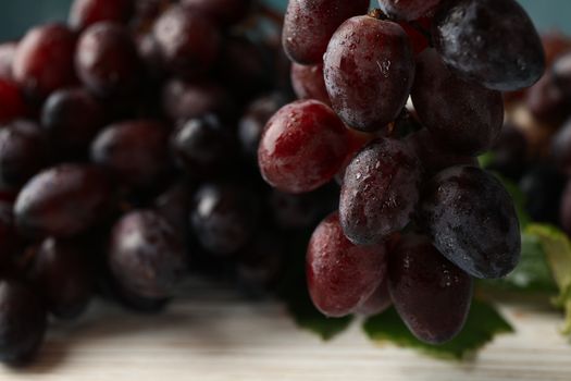 Fresh ripe grape on white wooden background