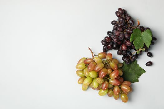 Fresh ripe grape with leaves on white background