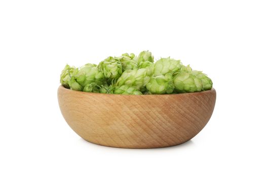 Wooden bowl with hop isolated on white background