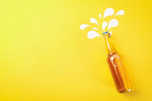 Bottle of beer on yellow background, space for text