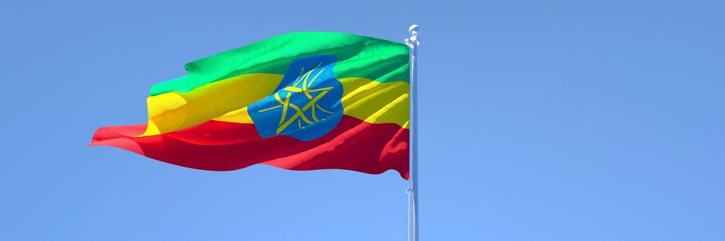 3D rendering of the national flag of Ethiopia waving in the wind against a blue sky