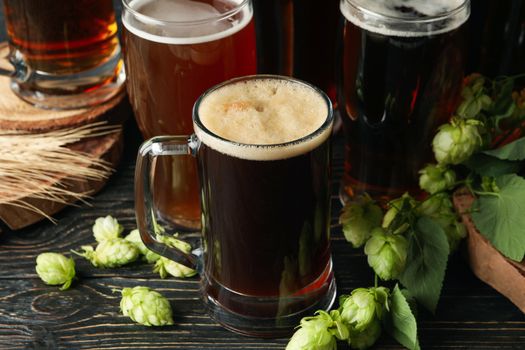 Beer, hop and wheat on wooden table